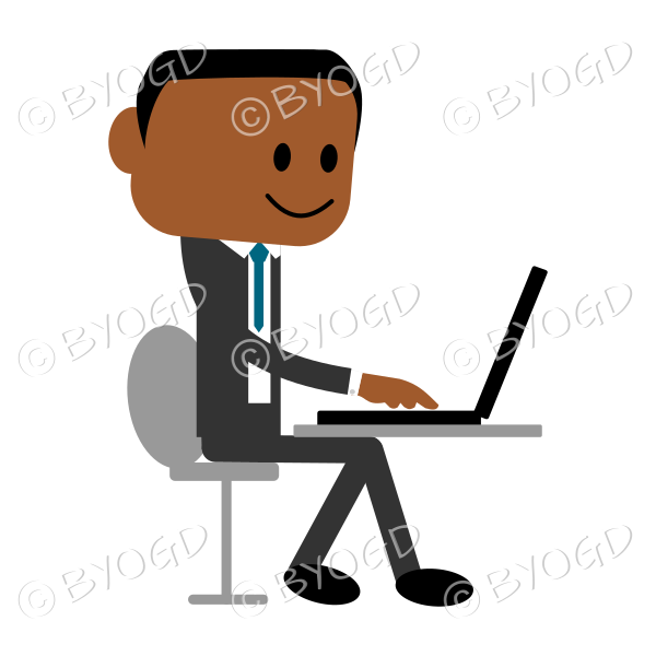 Young man in a business suit using laptop computer.